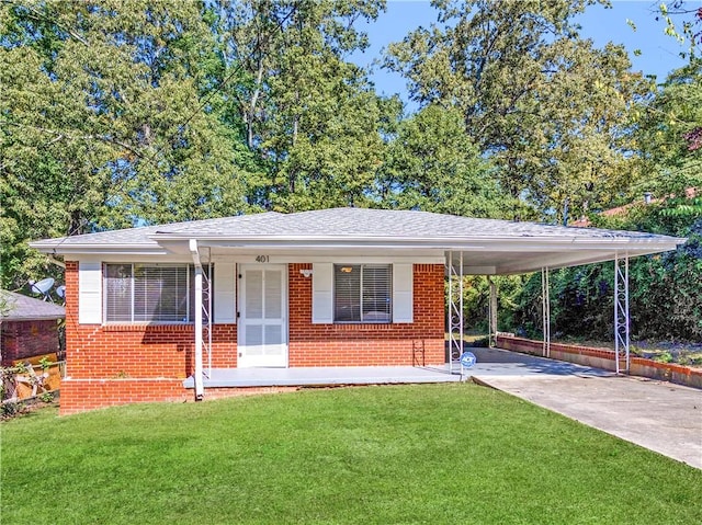 view of front of house with a front lawn and a carport