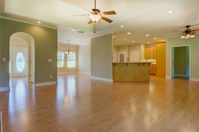 172 Lakeview Dr, Newborn, GA 30056 - unfurnished living room with ceiling fan, crown molding, arched walkways, light wood-type flooring, and recessed lighting