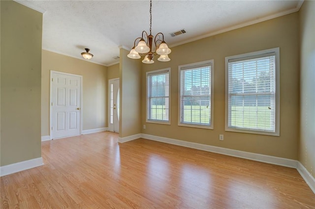 172 Lakeview Dr, Newborn, GA 30056 - spare room with a chandelier, plenty of natural light, light wood-style floors, crown molding, and a textured ceiling