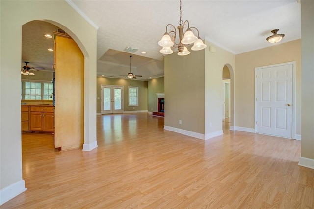 172 Lakeview Dr, Newborn, GA 30056 - empty room featuring a ceiling fan, arched walkways, ornamental molding, light wood-style floors, and a chandelier
