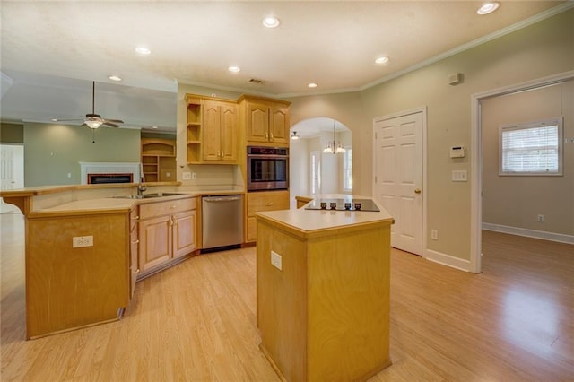 172 Lakeview Dr, Newborn, GA 30056 - kitchen featuring appliances with stainless steel finishes, a ceiling fan, a kitchen island, a fireplace, and arched walkways