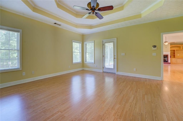 172 Lakeview Dr, Newborn, GA 30056 - unfurnished room featuring ornamental molding, ceiling fan, light wood-style flooring, and a tray ceiling