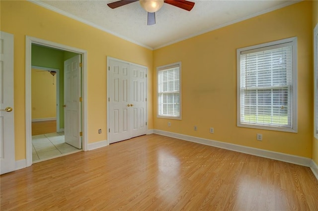 172 Lakeview Dr, Newborn, GA 30056 - unfurnished bedroom with light wood-style flooring, crown molding, ensuite bath, and a ceiling fan