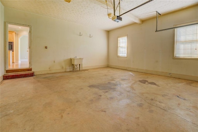 172 Lakeview Dr, Newborn, GA 30056 - garage featuring a garage door opener and a sink