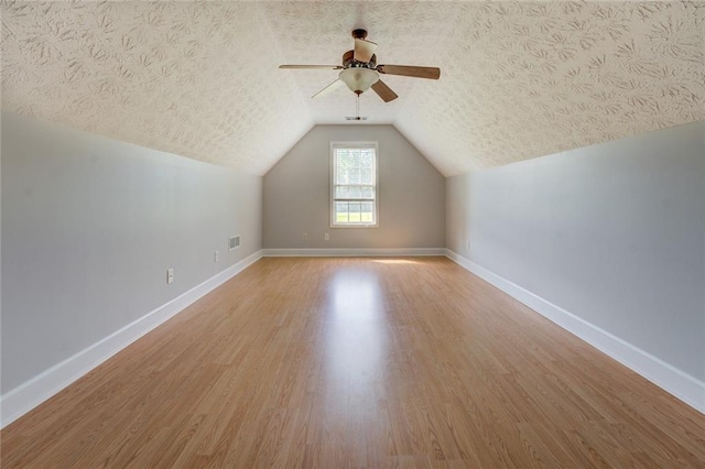 172 Lakeview Dr, Newborn, GA 30056 - bonus room with ceiling fan, wood finished floors, vaulted ceiling, and a textured ceiling