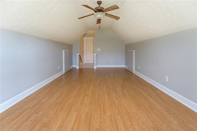 172 Lakeview Dr, Newborn, GA 30056 - additional living space featuring a ceiling fan, a textured ceiling, light wood finished floors, and lofted ceiling