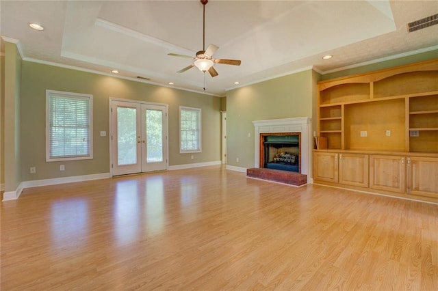 172 Lakeview Dr, Newborn, GA 30056 - unfurnished living room featuring ornamental molding, light wood-style floors, a fireplace, ceiling fan, and french doors