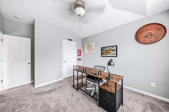 carpeted home office with vaulted ceiling, ceiling fan, and baseboards