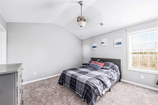 bedroom with carpet, visible vents, baseboards, and vaulted ceiling