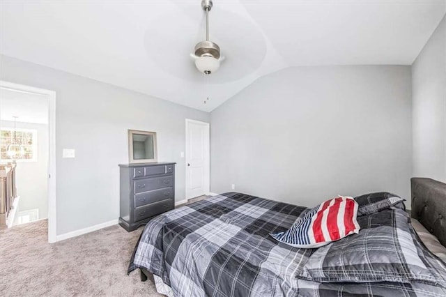 bedroom with a ceiling fan, lofted ceiling, carpet flooring, and baseboards