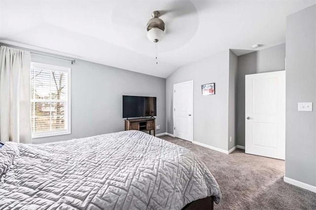 bedroom featuring a ceiling fan, carpet, vaulted ceiling, and baseboards