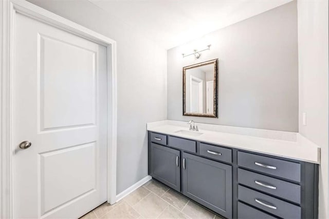 bathroom with tile patterned flooring, vanity, and baseboards