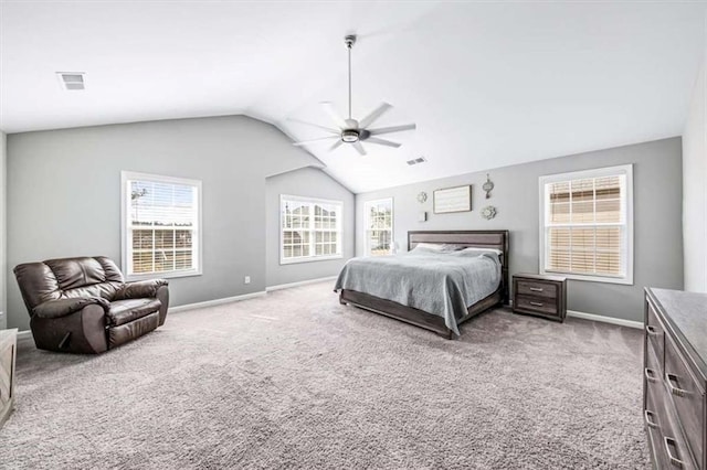 carpeted bedroom with lofted ceiling, baseboards, multiple windows, and visible vents