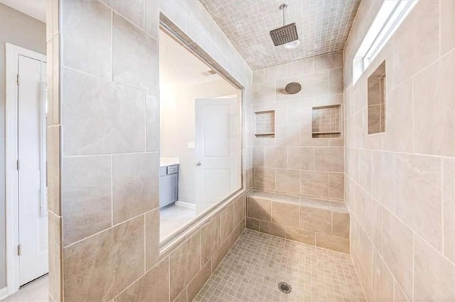 full bath featuring tiled shower