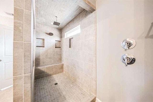 bathroom with a tile shower