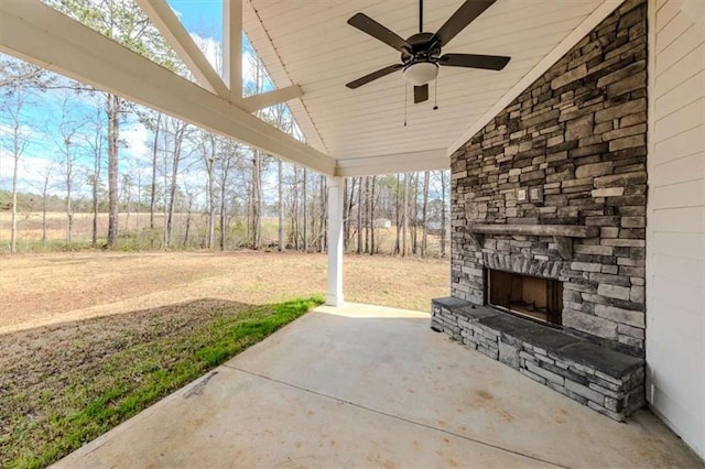 view of patio / terrace with an outdoor stone fireplace and ceiling fan