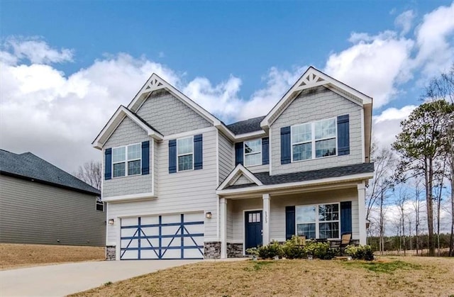 craftsman inspired home with a garage and concrete driveway