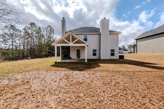 rear view of house featuring a patio, a chimney, and central AC unit