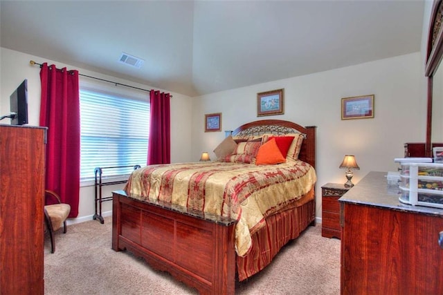 carpeted bedroom with vaulted ceiling