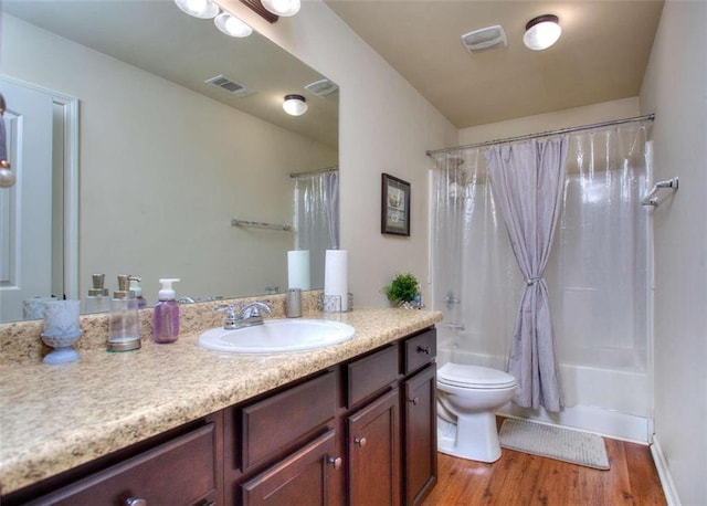 full bathroom featuring vanity, shower / bathtub combination with curtain, wood-type flooring, and toilet