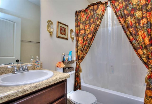 full bathroom with vanity, shower / bath combination with curtain, and toilet