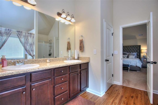 bathroom featuring vanity, an enclosed shower, and hardwood / wood-style flooring