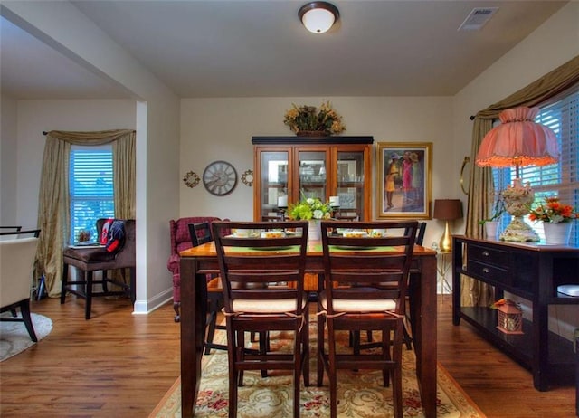 dining space with hardwood / wood-style floors