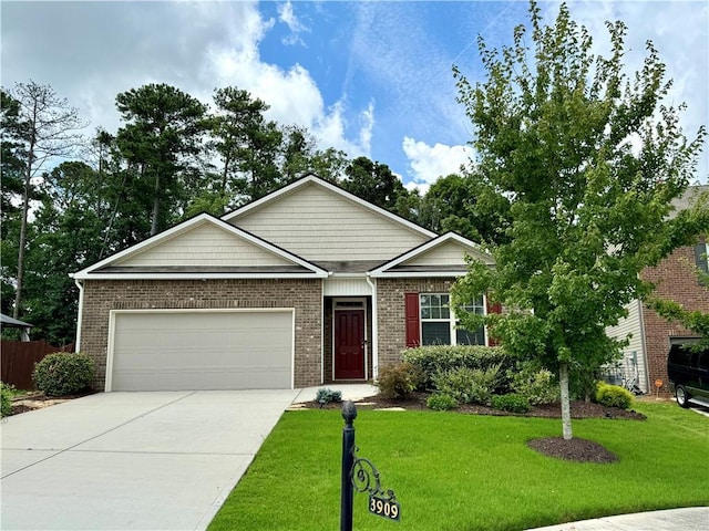 view of front of property featuring a garage and a front lawn