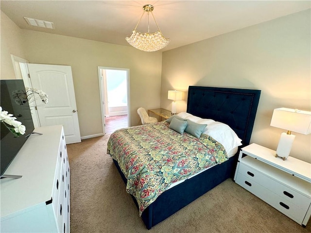 bedroom with carpet flooring and a notable chandelier