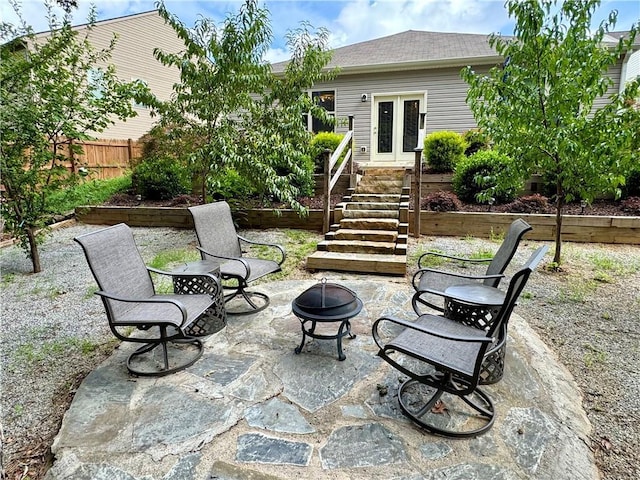 view of patio with french doors and a fire pit