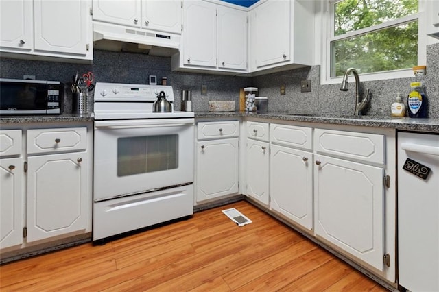 141 Mills Creek Path, Hiram, GA 30141 - kitchen with white appliances, under cabinet range hood, dark countertops, white cabinetry, and a sink