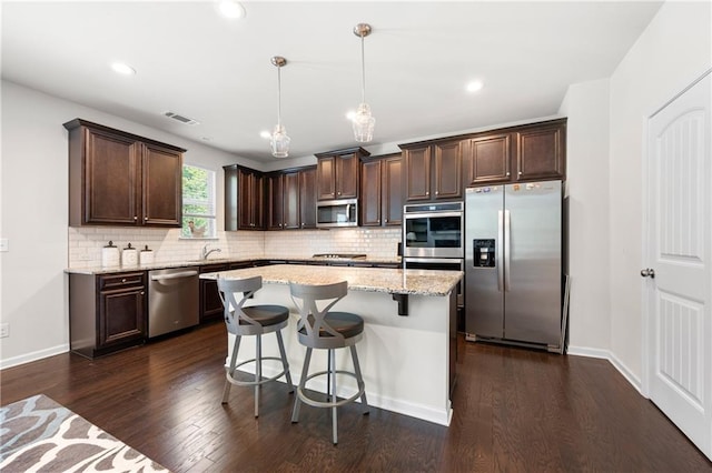 kitchen featuring visible vents, appliances with stainless steel finishes, dark wood-style floors, and dark brown cabinets