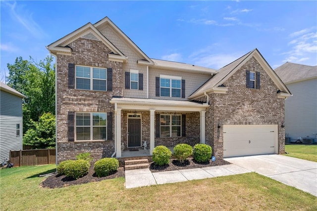 craftsman-style house featuring driveway, a front yard, a garage, brick siding, and fence