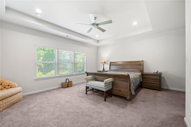 bedroom with baseboards, recessed lighting, a raised ceiling, and carpet floors