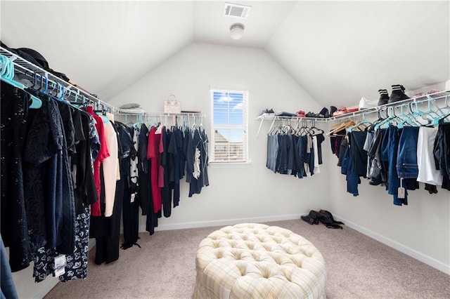 walk in closet featuring visible vents, carpet, and lofted ceiling