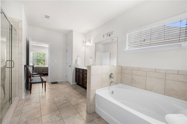 ensuite bathroom featuring ensuite bath, vanity, visible vents, a bath, and a stall shower