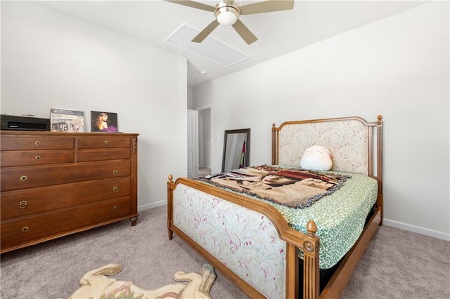 bedroom with light colored carpet, attic access, and baseboards