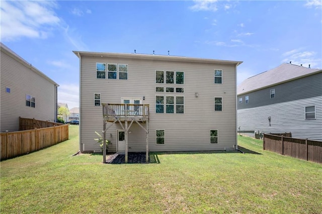 back of property with fence and a yard