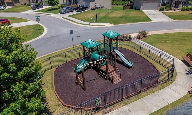 community playground with a lawn and fence
