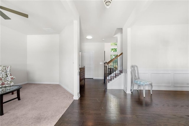 foyer featuring baseboards, ceiling fan, stairs, and wood finished floors