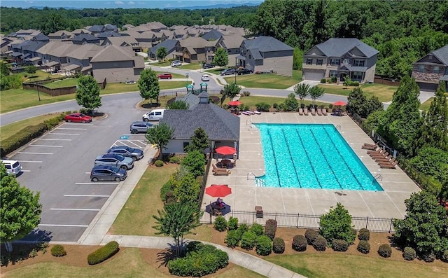 community pool with fence and a residential view