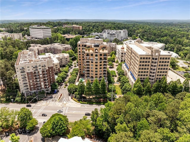 aerial view featuring a city view and a wooded view