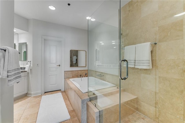 bathroom with recessed lighting, tile patterned flooring, a garden tub, and a stall shower