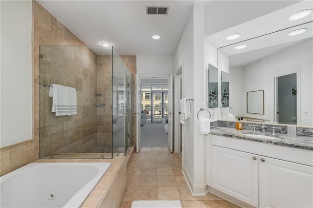 full bath with vanity, visible vents, a whirlpool tub, tile patterned floors, and a stall shower