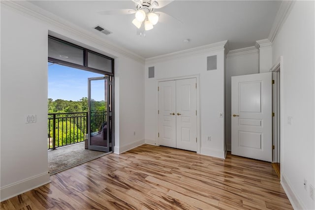 unfurnished bedroom featuring visible vents, access to exterior, ornamental molding, and light wood-type flooring