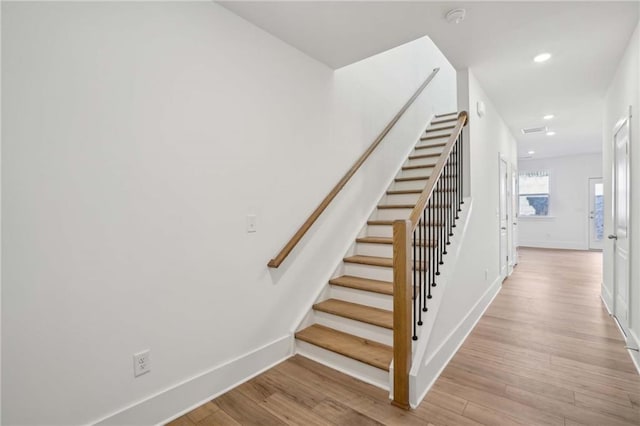 stairway featuring hardwood / wood-style flooring