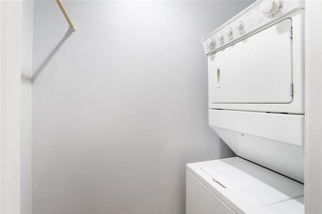 laundry room with stacked washer and clothes dryer and laundry area