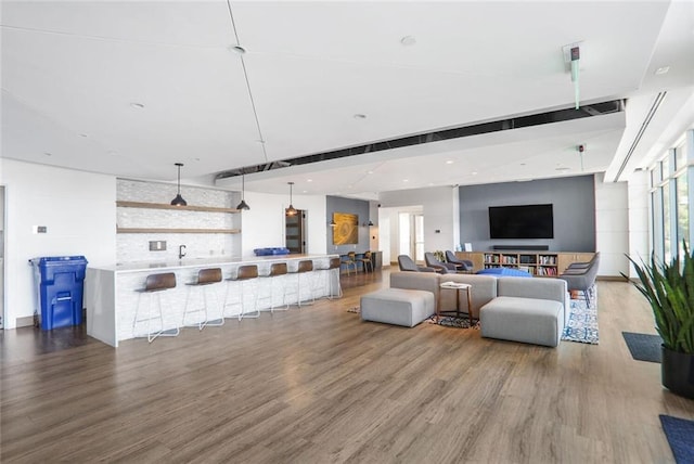 living room with plenty of natural light, recessed lighting, and wood finished floors