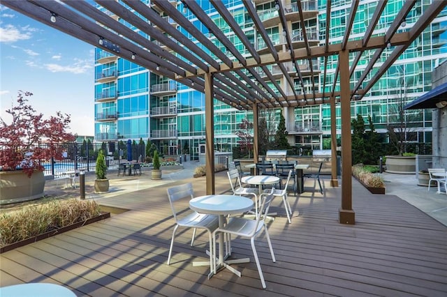 deck featuring a pergola and fence