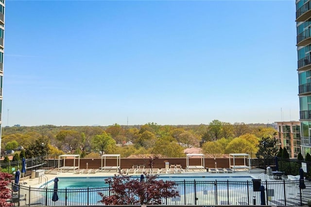 pool featuring a patio area and fence